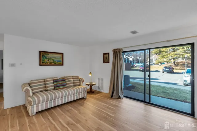 a bedroom with a bed and glass window