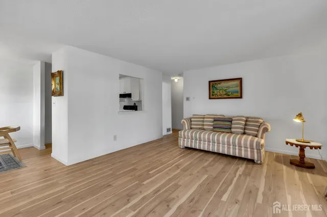 a view of room with furniture and wooden floor