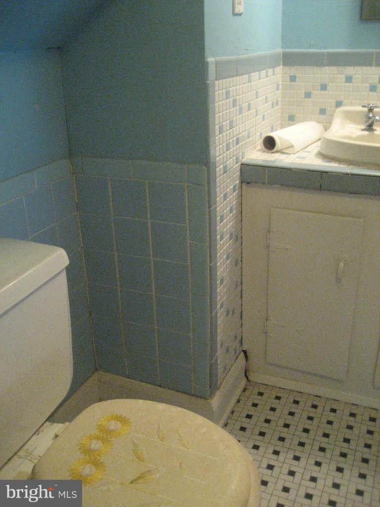 7413 Marston Road Baltimore, MD 21207 - Photo 12 of 16 a bathroom with a sink toilet and shower