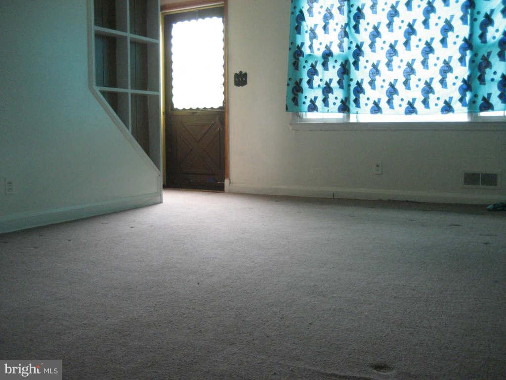 7413 Marston Road Baltimore, MD 21207 - Photo 2 of 16 a view of an empty room with a window