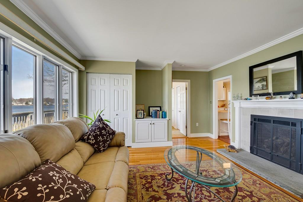 15 Greycliff Road Brighton, MA 02135 - Photo 12 of 41 a living room with furniture a flat screen tv and a fireplace