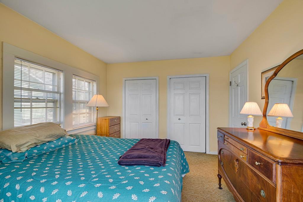 15 Greycliff Road Brighton, MA 02135 - Photo 18 of 41 a bedroom with a bed and a dresser next to a window