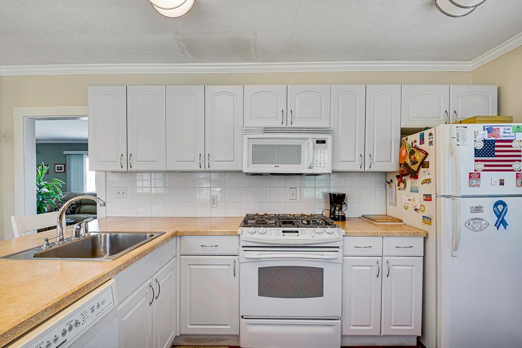 15 Greycliff Road Brighton, MA 02135 - Photo 6 of 41 a kitchen with cabinets appliances a sink and a counter top space
