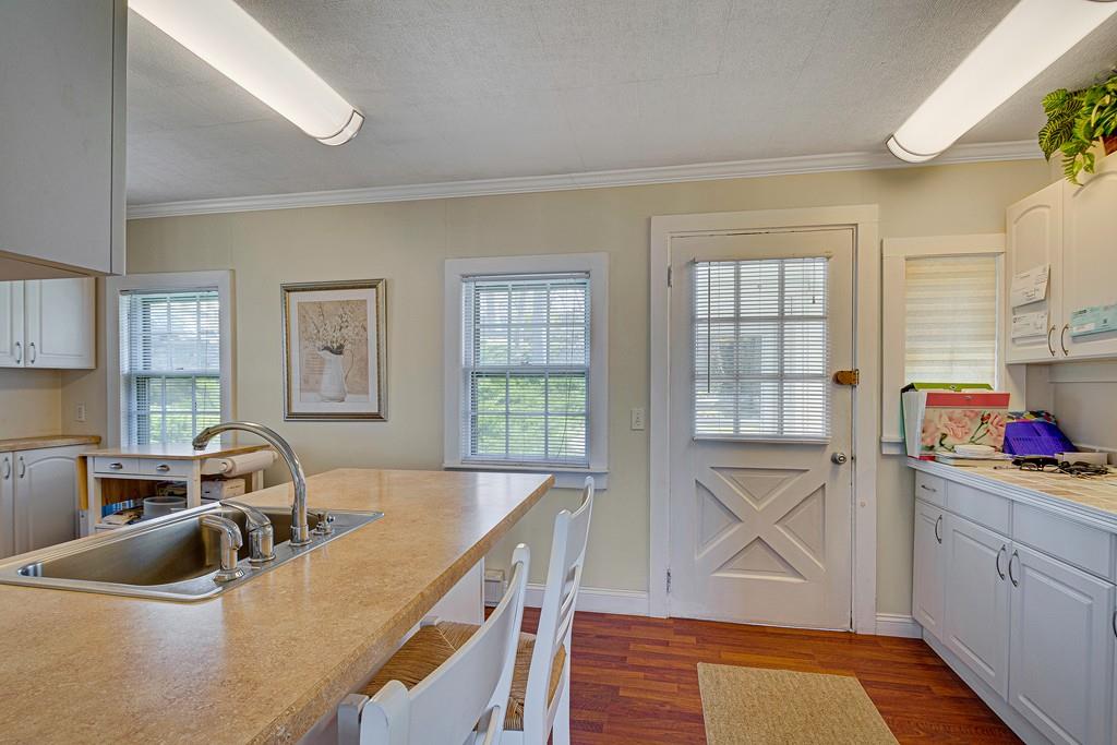 15 Greycliff Road Brighton, MA 02135 - Photo 8 of 41 a kitchen with a sink stove and cabinets