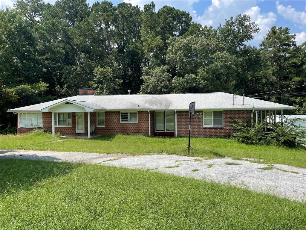 3133 Bomar Road Douglasville, GA 30135 - Photo 1 of 1 a view of a house with a backyard
