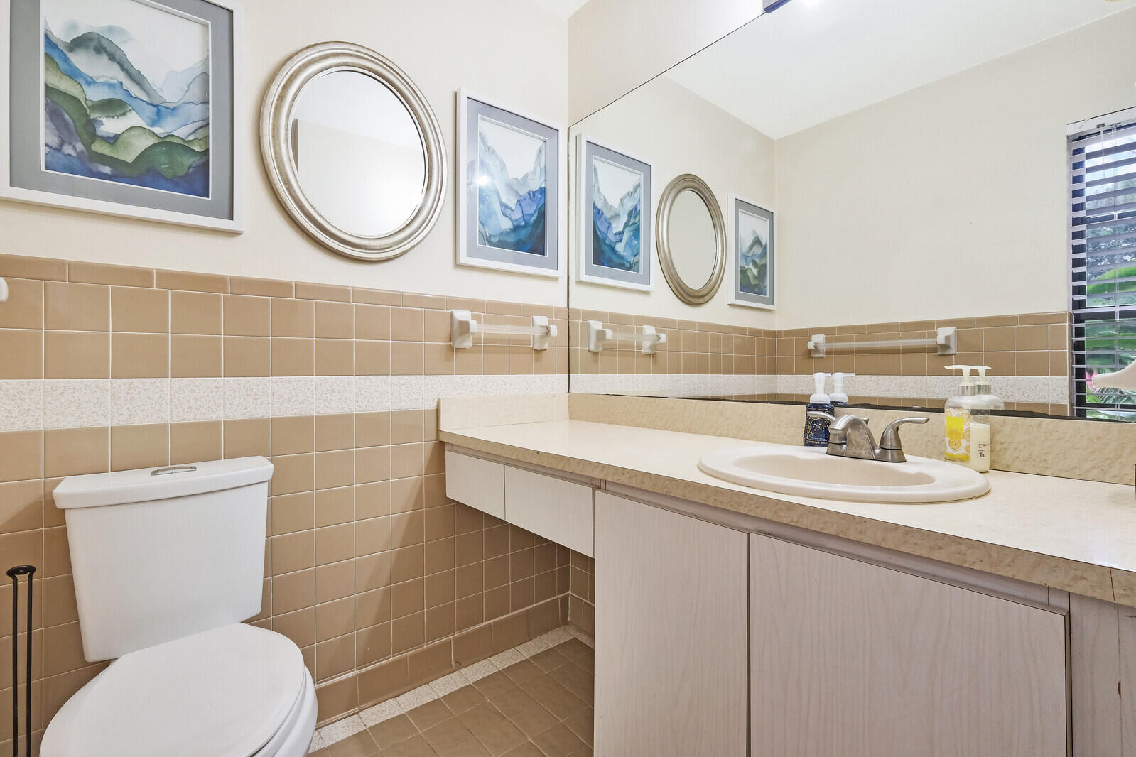 17520 Bridle Court Jupiter, FL 33478 - Photo 14 of 35 a bathroom with a toilet a sink and a mirror