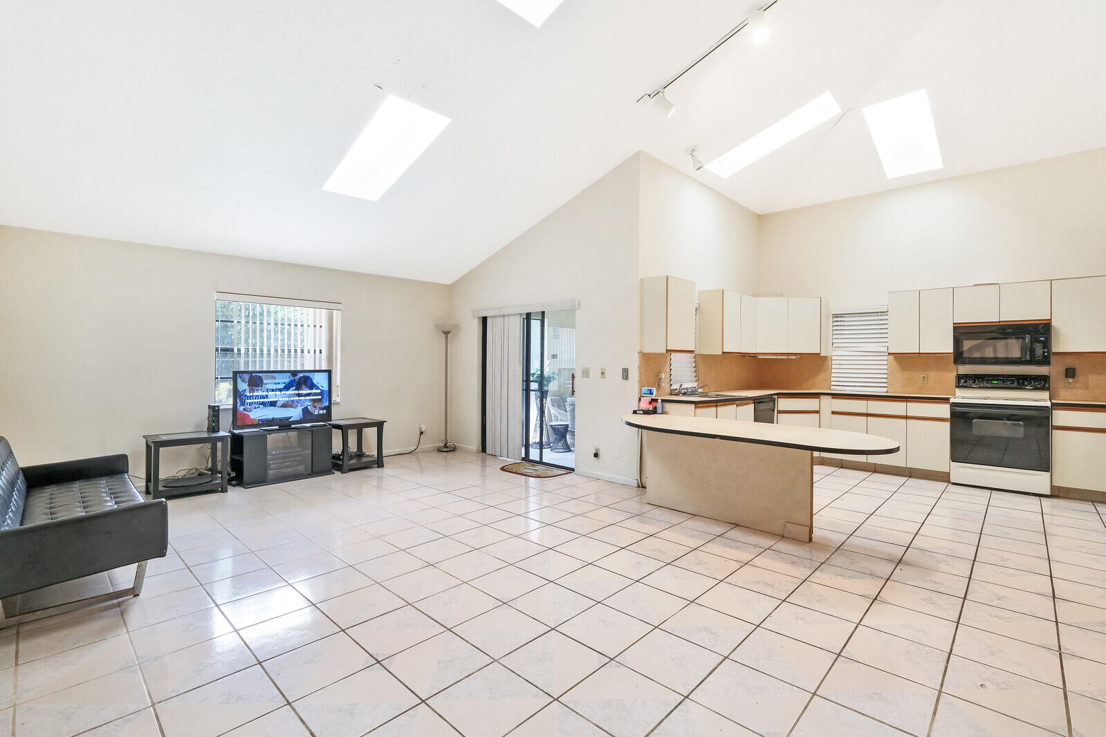 17520 Bridle Court Jupiter, FL 33478 - Photo 18 of 35 a kitchen with stainless steel appliances kitchen island granite countertop a sink and cabinets