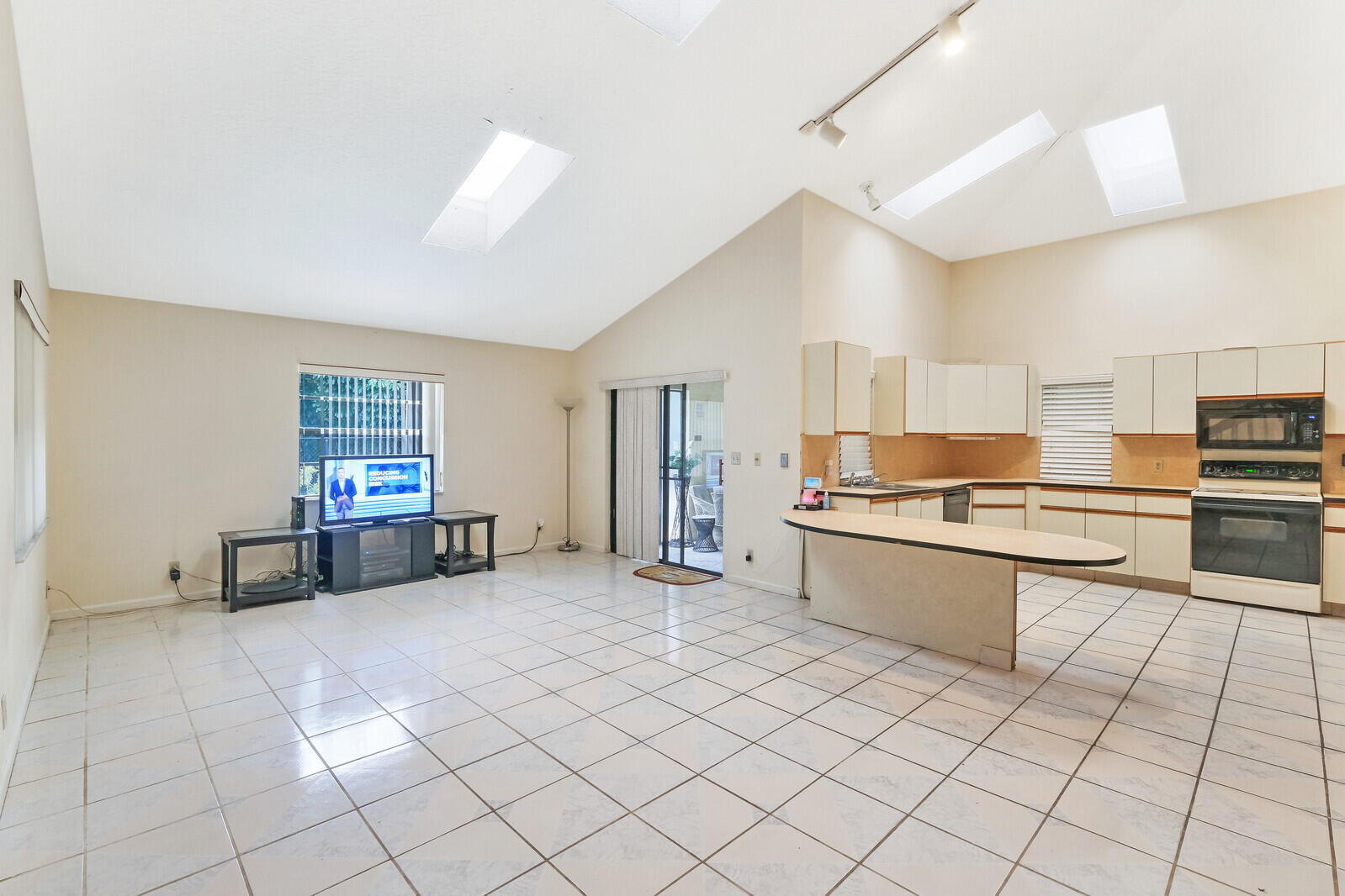 17520 Bridle Court Jupiter, FL 33478 - Photo 20 of 35 a large white kitchen with a stove a sink dishwasher and a refrigerator