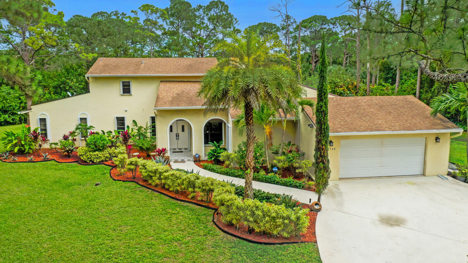 17520 Bridle Court Jupiter, FL 33478 - Photo 2 of 35 a front view of a house with garden