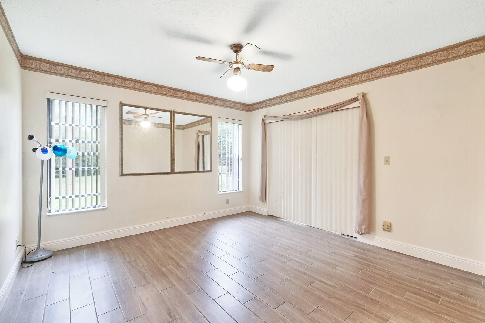 17520 Bridle Court Jupiter, FL 33478 - Photo 22 of 35 a view of an empty room with a window and wooden floor