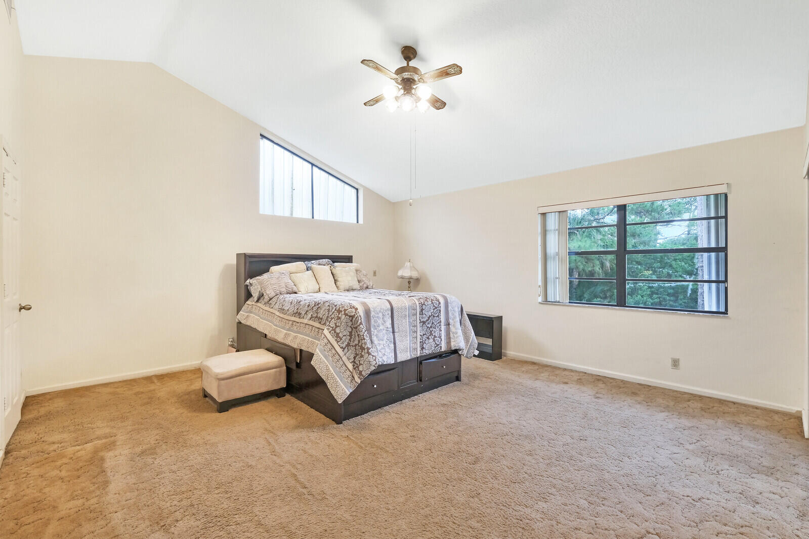 17520 Bridle Court Jupiter, FL 33478 - Photo 27 of 35 a spacious bedroom with a bed and a window