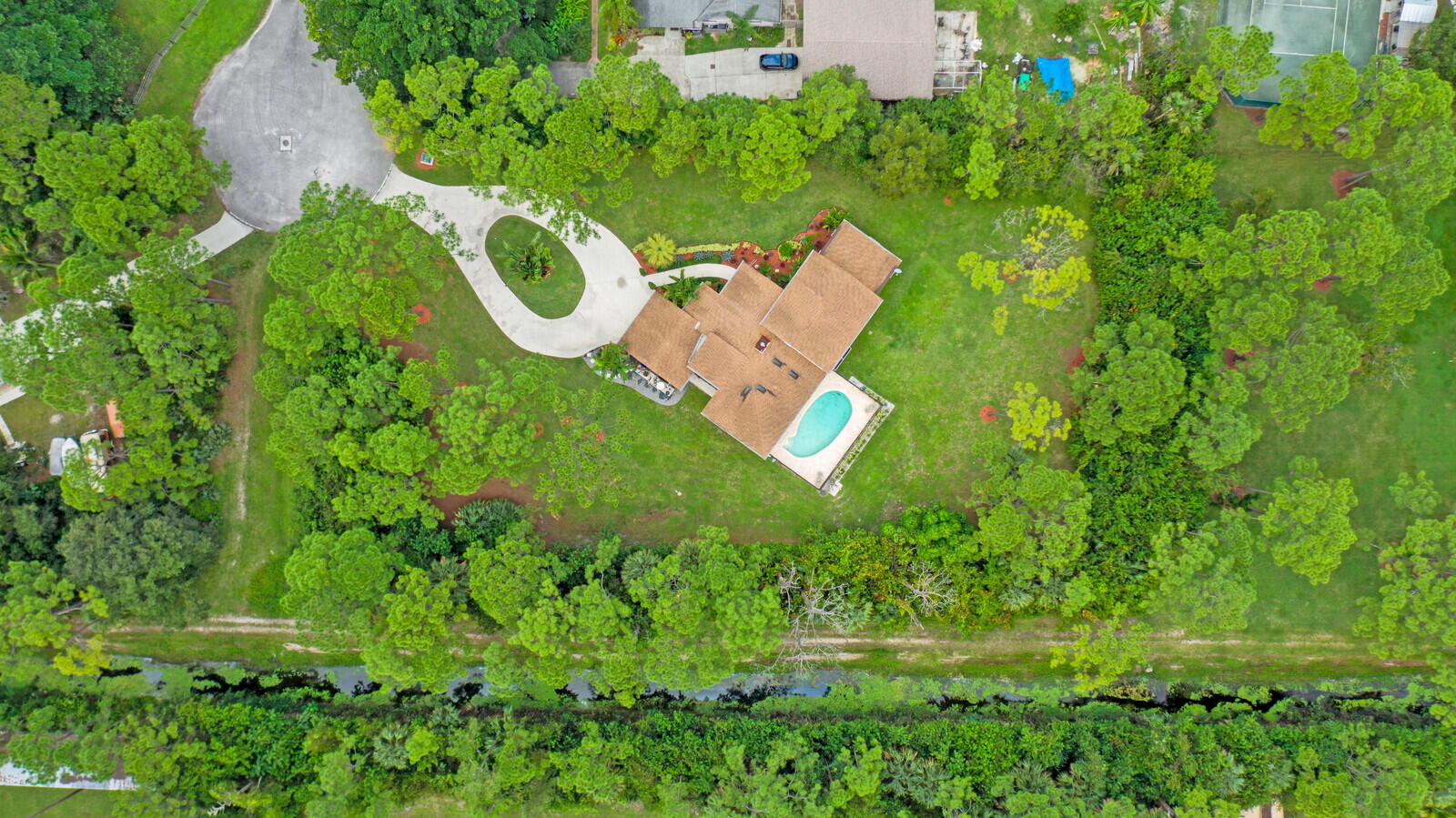 17520 Bridle Court Jupiter, FL 33478 - Photo 4 of 35 an aerial view of a house with a yard and lake view