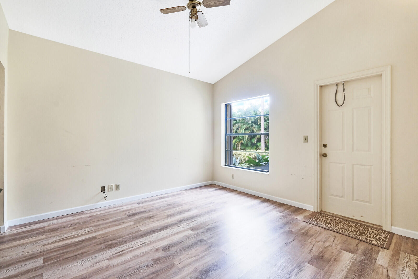 17520 Bridle Court Jupiter, FL 33478 - Photo 7 of 35 an empty room with a window and a ceiling fan