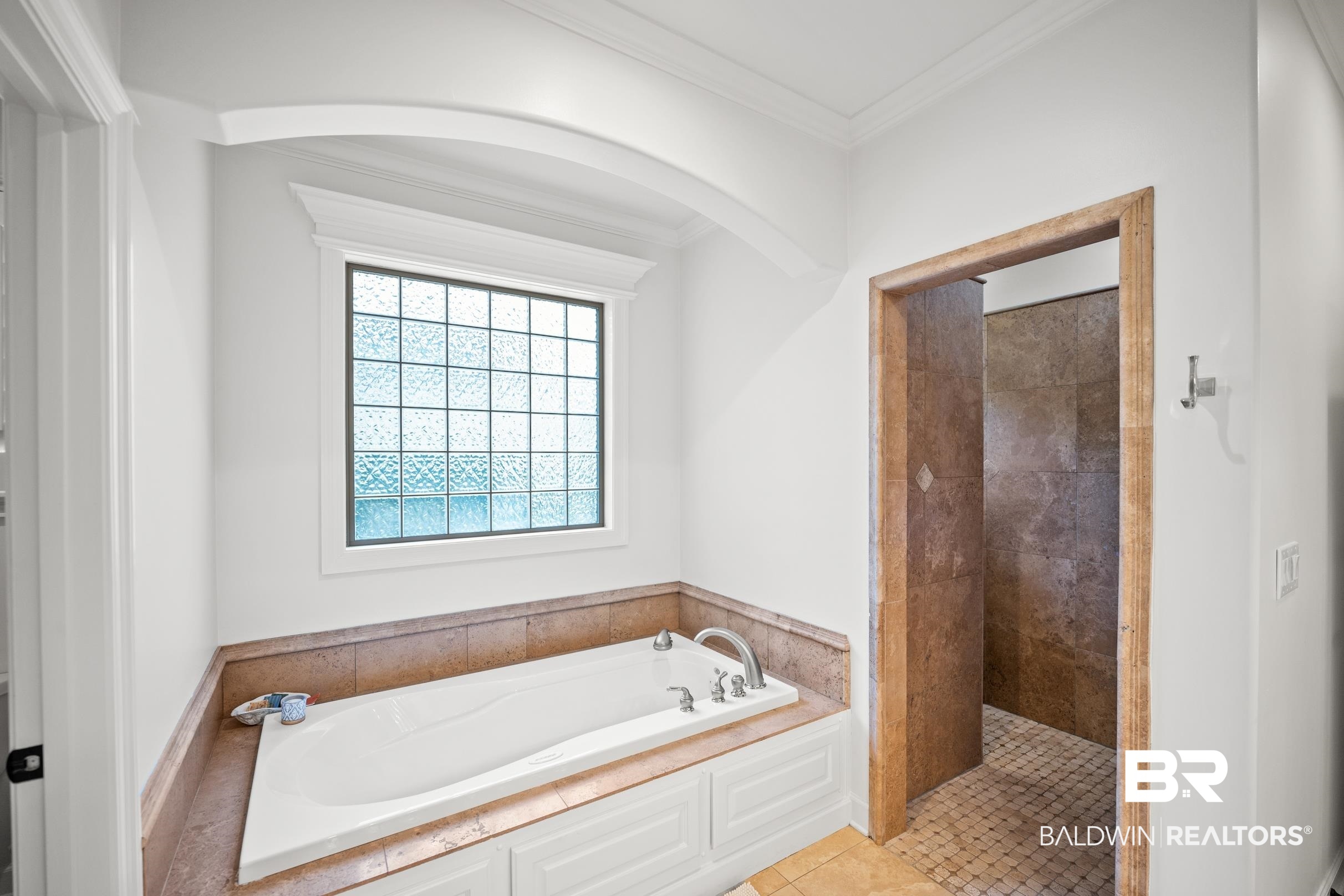 115 Sandy Ford Road Fairhope, AL 36532 - Photo 31 of 47 Bathroom featuring a garden tub, crown molding, a tile shower, and tile patterned floors