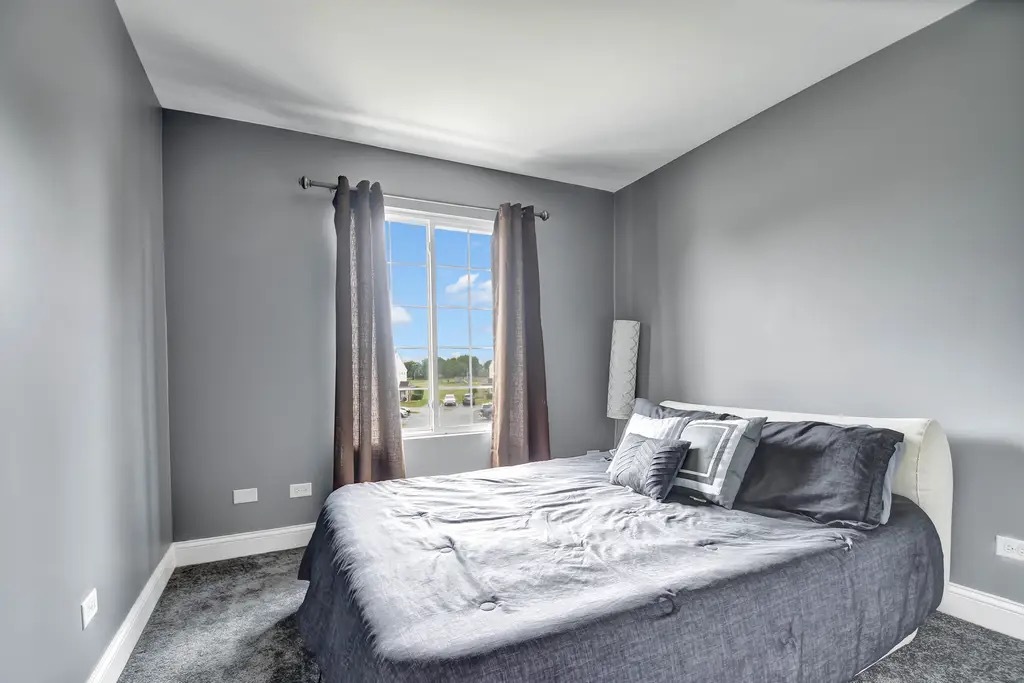 142 Azalea Circle Romeoville, IL 60446 - Photo 13 of 15 a bedroom with a bed and window