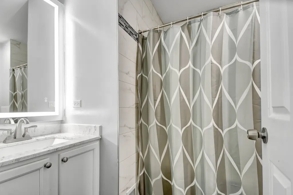 142 Azalea Circle Romeoville, IL 60446 - Photo 14 of 15 a bathroom with a granite countertop sink and a mirror