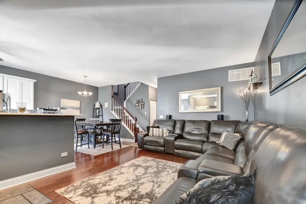 142 Azalea Circle Romeoville, IL 60446 - Photo 2 of 15 a living room with furniture and a wooden floor