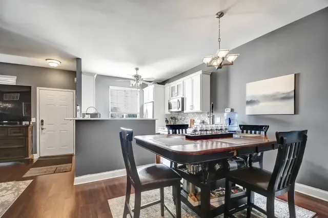 a view of a dining room and a kitchen with a dining table chairs