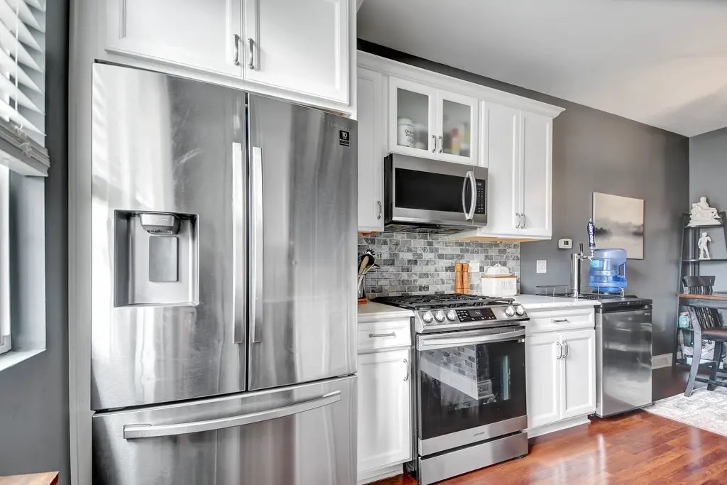 142 Azalea Circle Romeoville, IL 60446 - Photo 9 of 15 a kitchen with stainless steel appliances a refrigerator stove and microwave