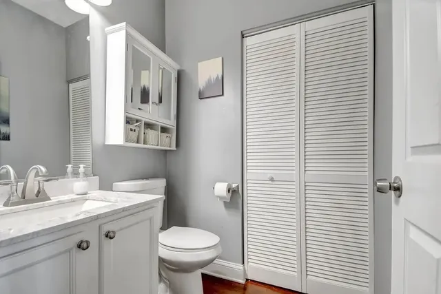 a bathroom with a toilet a sink and mirror