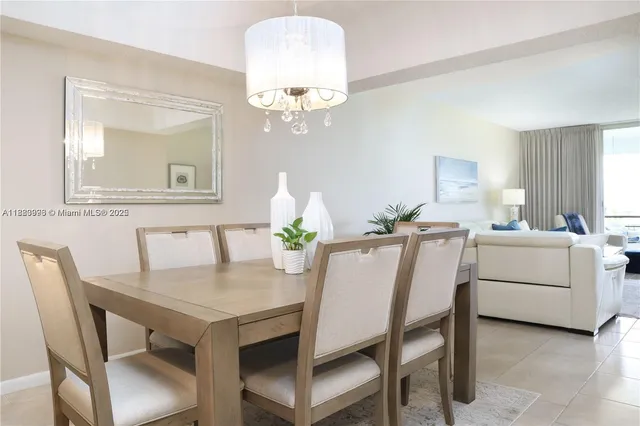 a view of a dining room with furniture and a chandelier