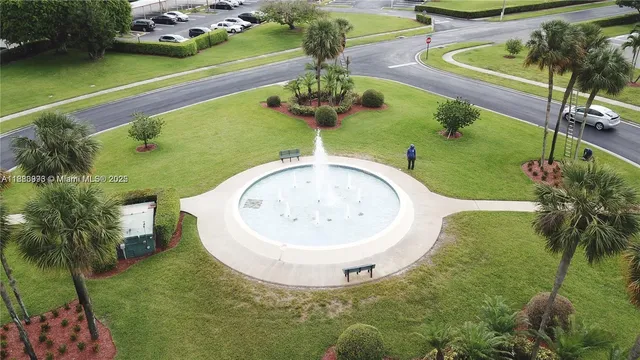 a view of a swimming pool with a garden and sitting space