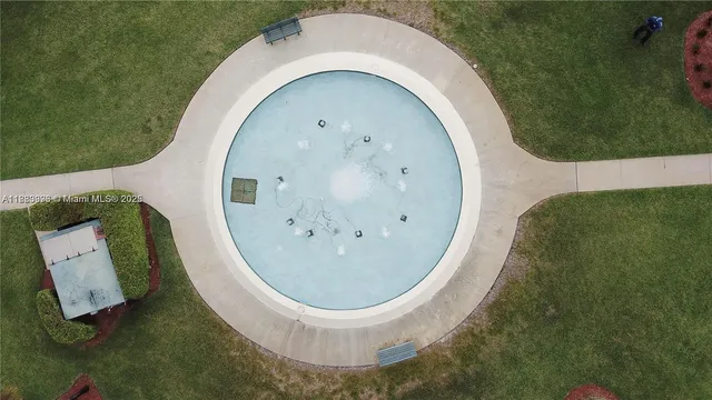 an aerial view of a pool yard patio and outdoor kitchen