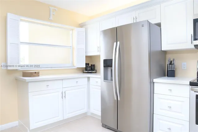 a view of a kitchen with a sink and cabinets