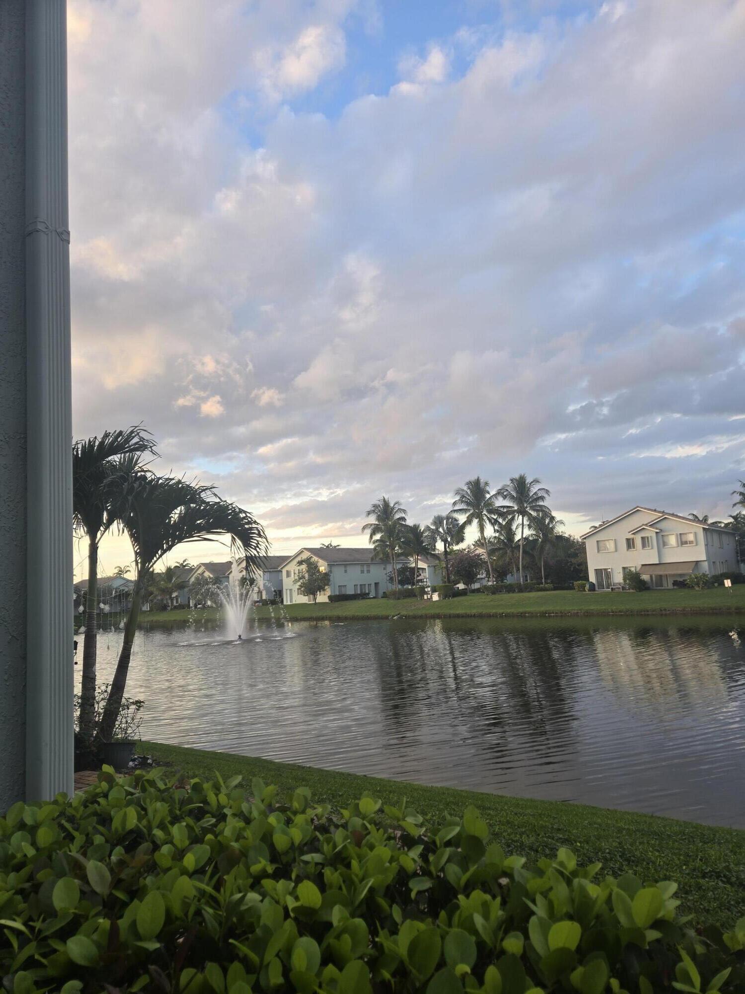 3182 Laurel Ridge Circle Riviera Beach, FL 33404 - Photo 11 of 29 a view of a lake with houses in the back