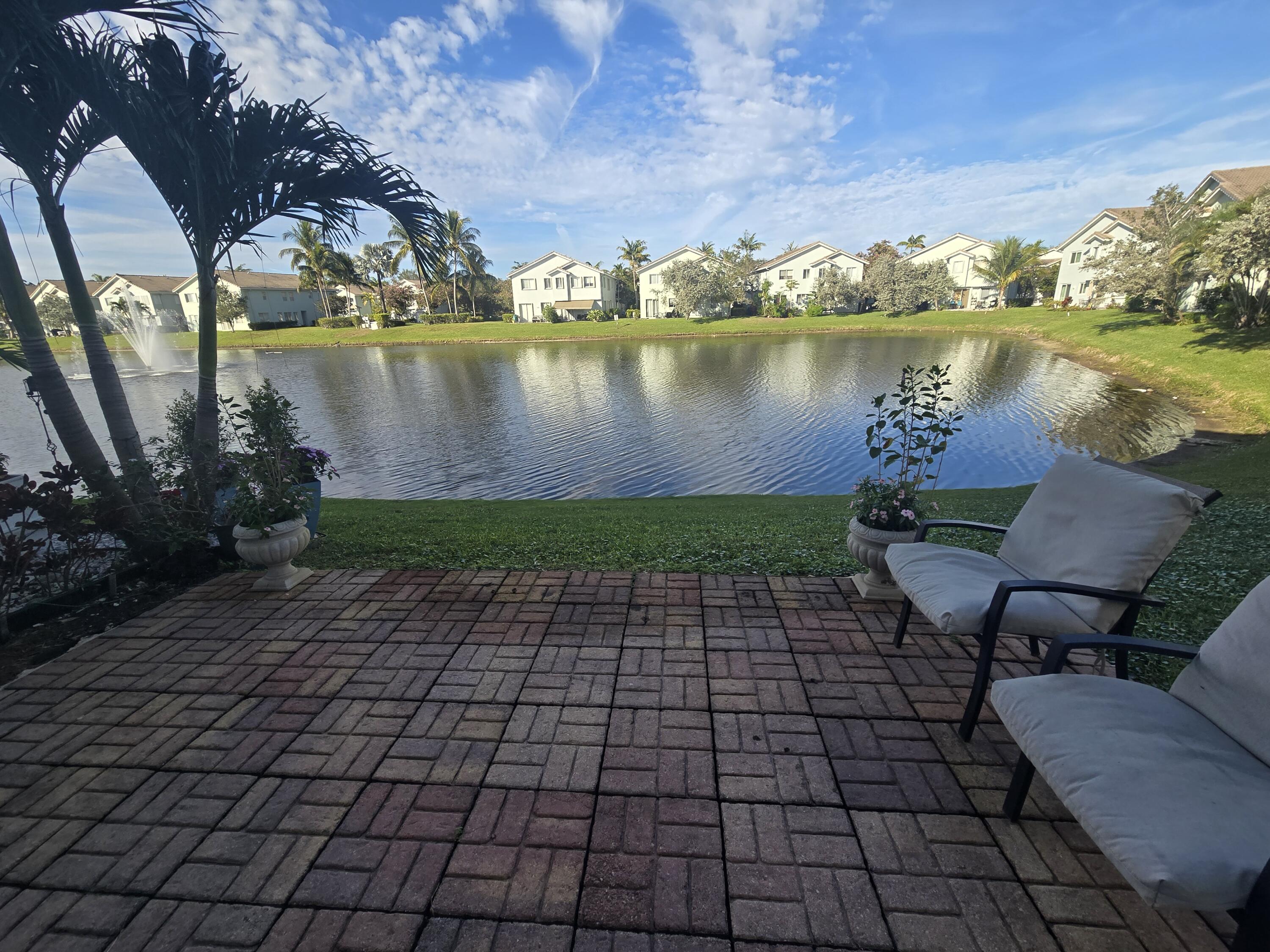 3182 Laurel Ridge Circle Riviera Beach, FL 33404 - Photo 20 of 29 a view of a lake with outside seating space