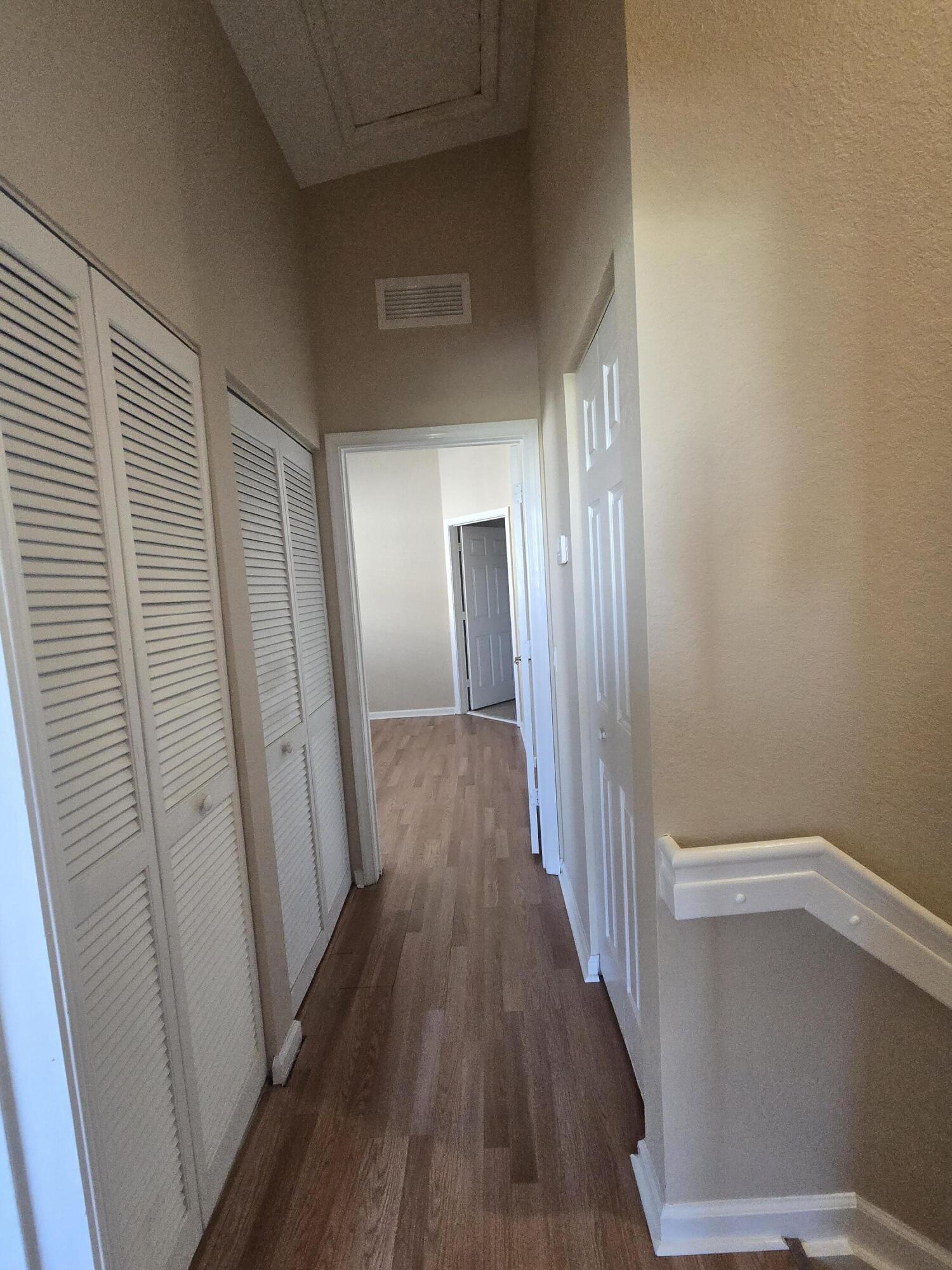 3182 Laurel Ridge Circle Riviera Beach, FL 33404 - Photo 23 of 29 a view of a hallway with wooden floor