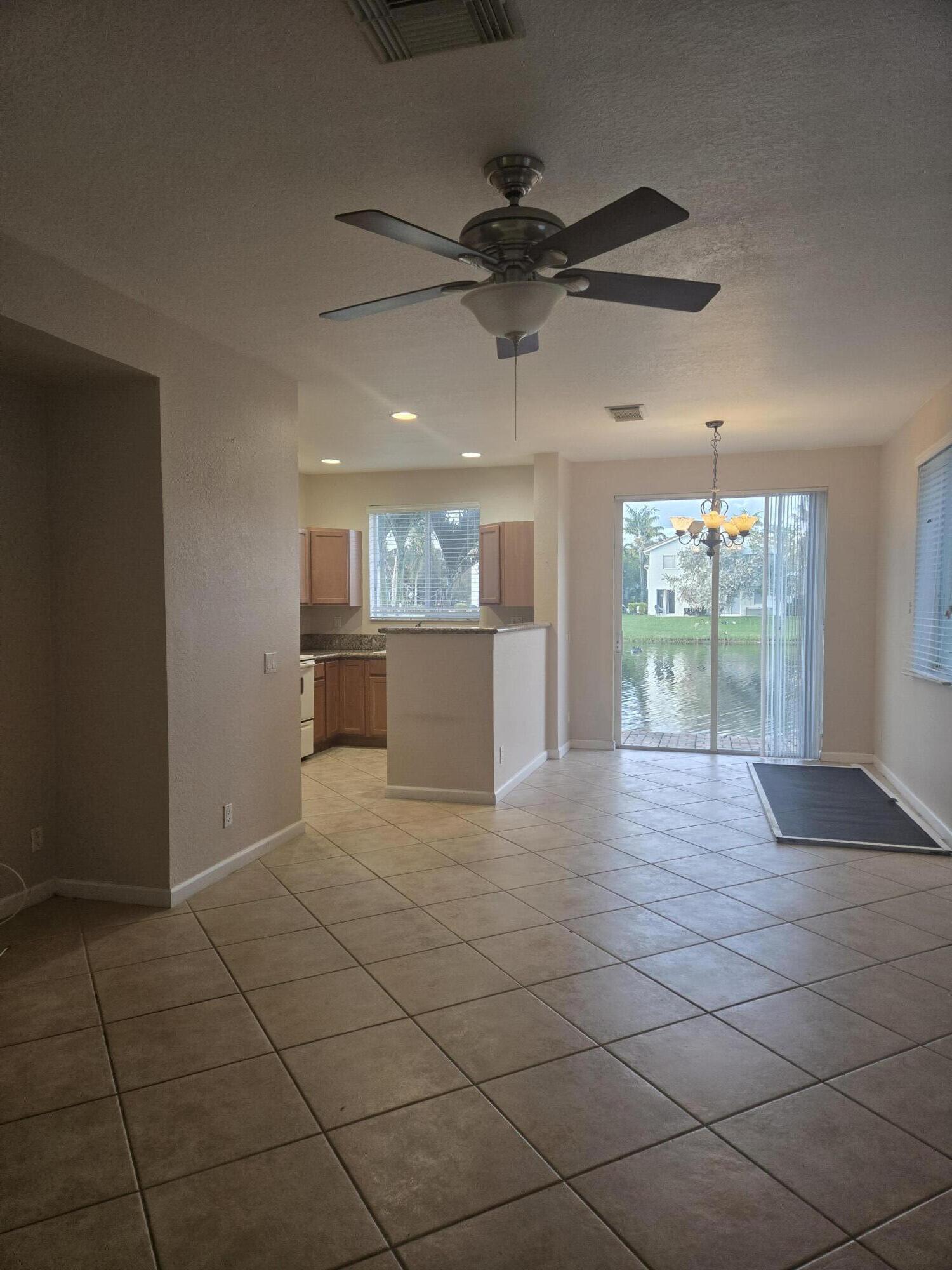 3182 Laurel Ridge Circle Riviera Beach, FL 33404 - Photo 8 of 29 wooden floor in an empty room with a window