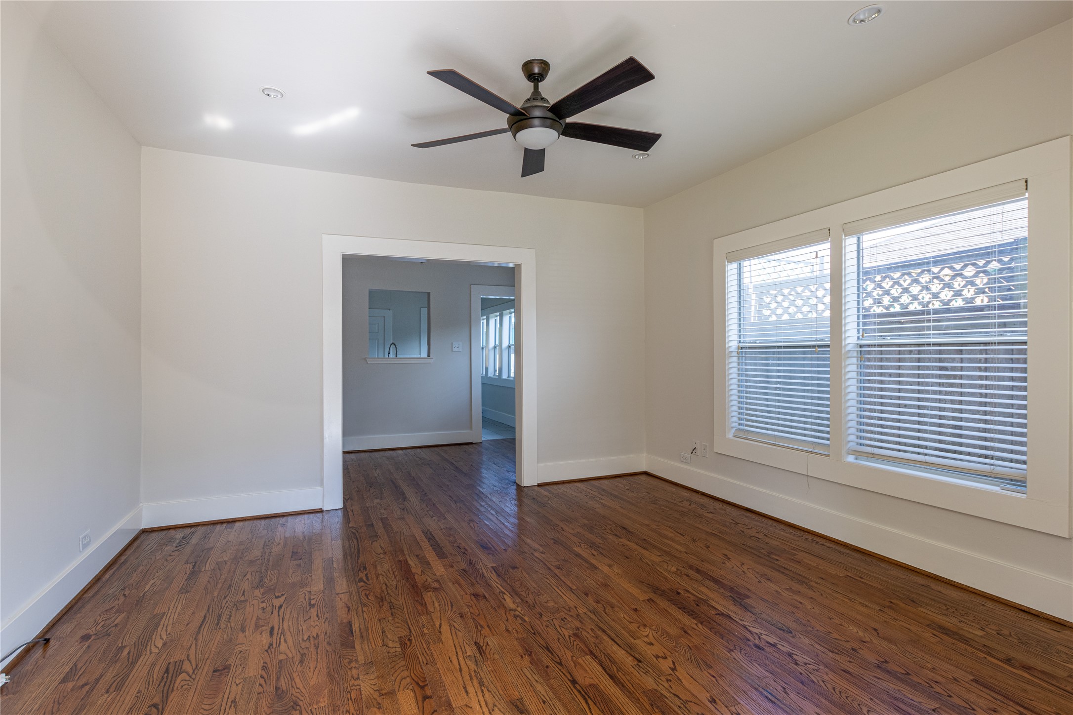 2009 Singleton Street Houston, TX 77008 - Photo 7 of 24 an empty room with wooden floor fan and windows