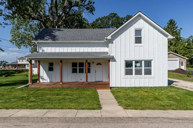 a front view of a house with a yard and porch