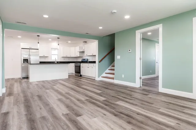 a view of kitchen with sink microwave and refrigerator
