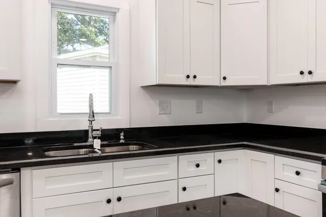 a close view of sink and cabinets
