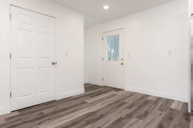 an empty room with wooden floor and closet