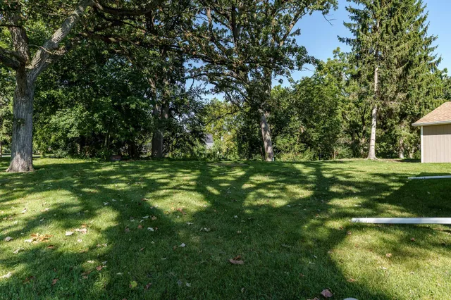 a view of outdoor space with green field and trees
