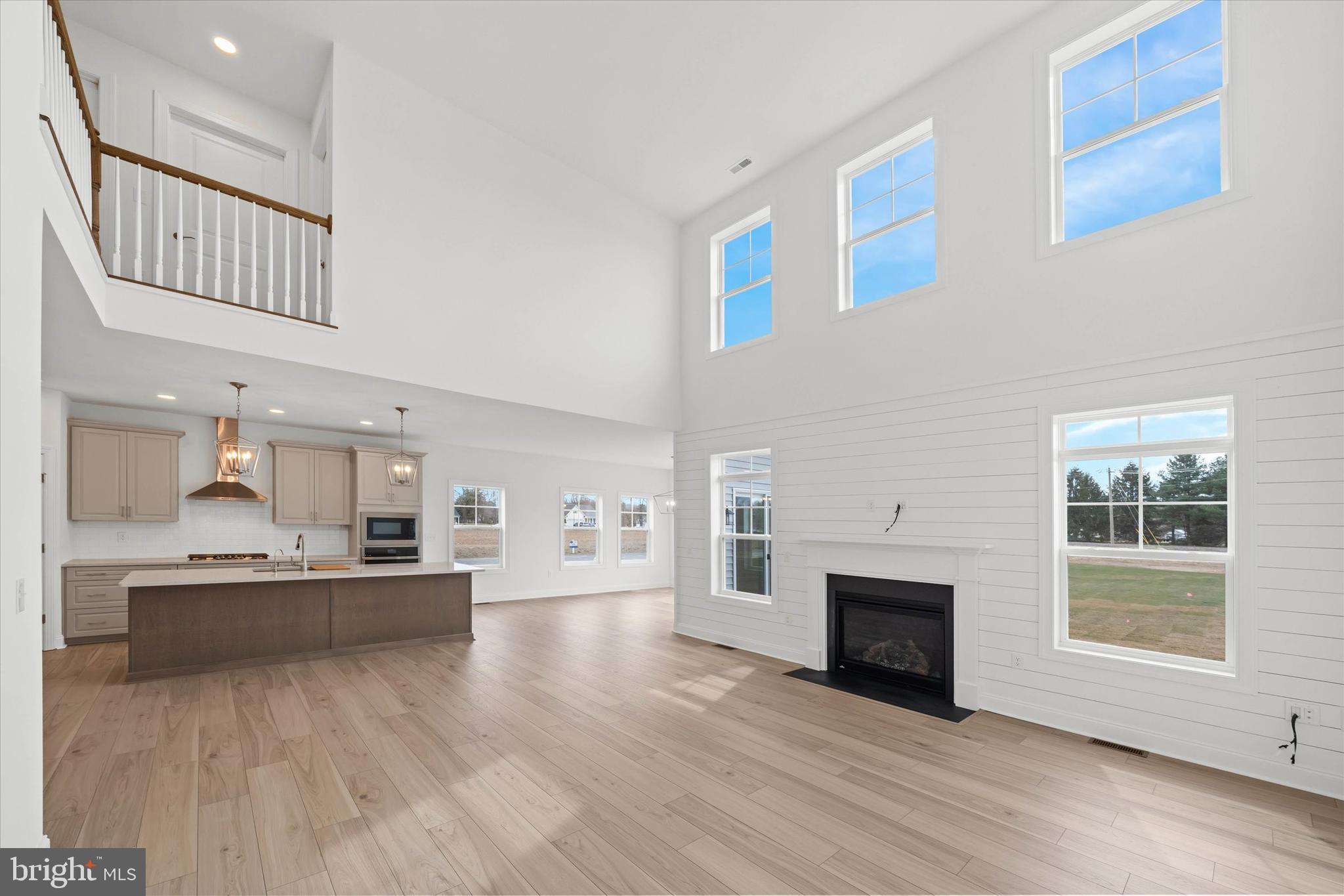 Lot#20 Hummingbird Road Ellendale, DE 19941 - Photo 12 of 41 a living room with stainless steel appliances kitchen island a table and a fireplace