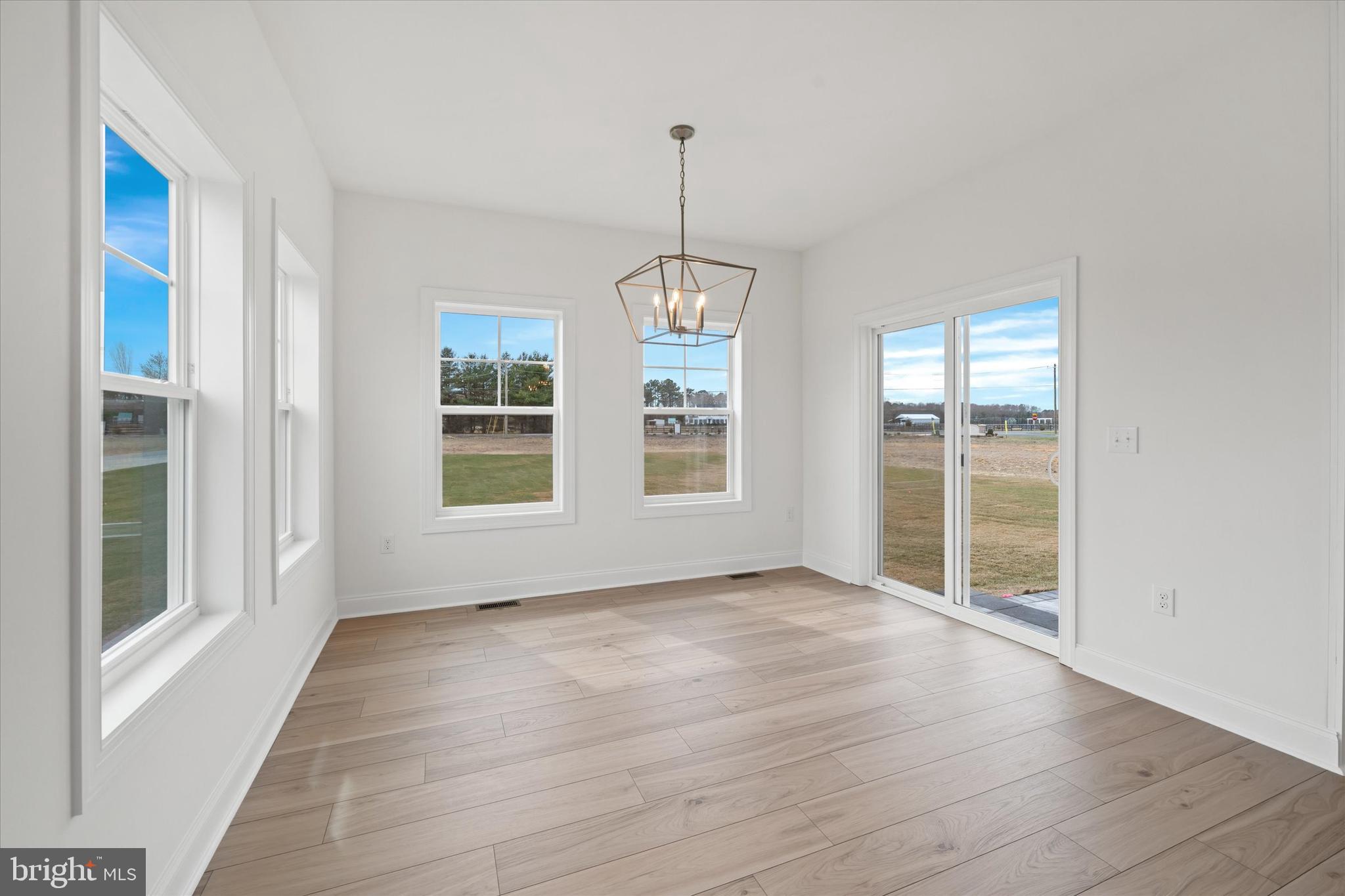 Lot#20 Hummingbird Road Ellendale, DE 19941 - Photo 17 of 41 a view of an empty room with wooden floor and a window