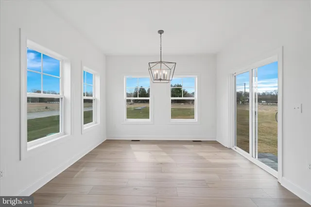 a view of wooden floor and windows in a room