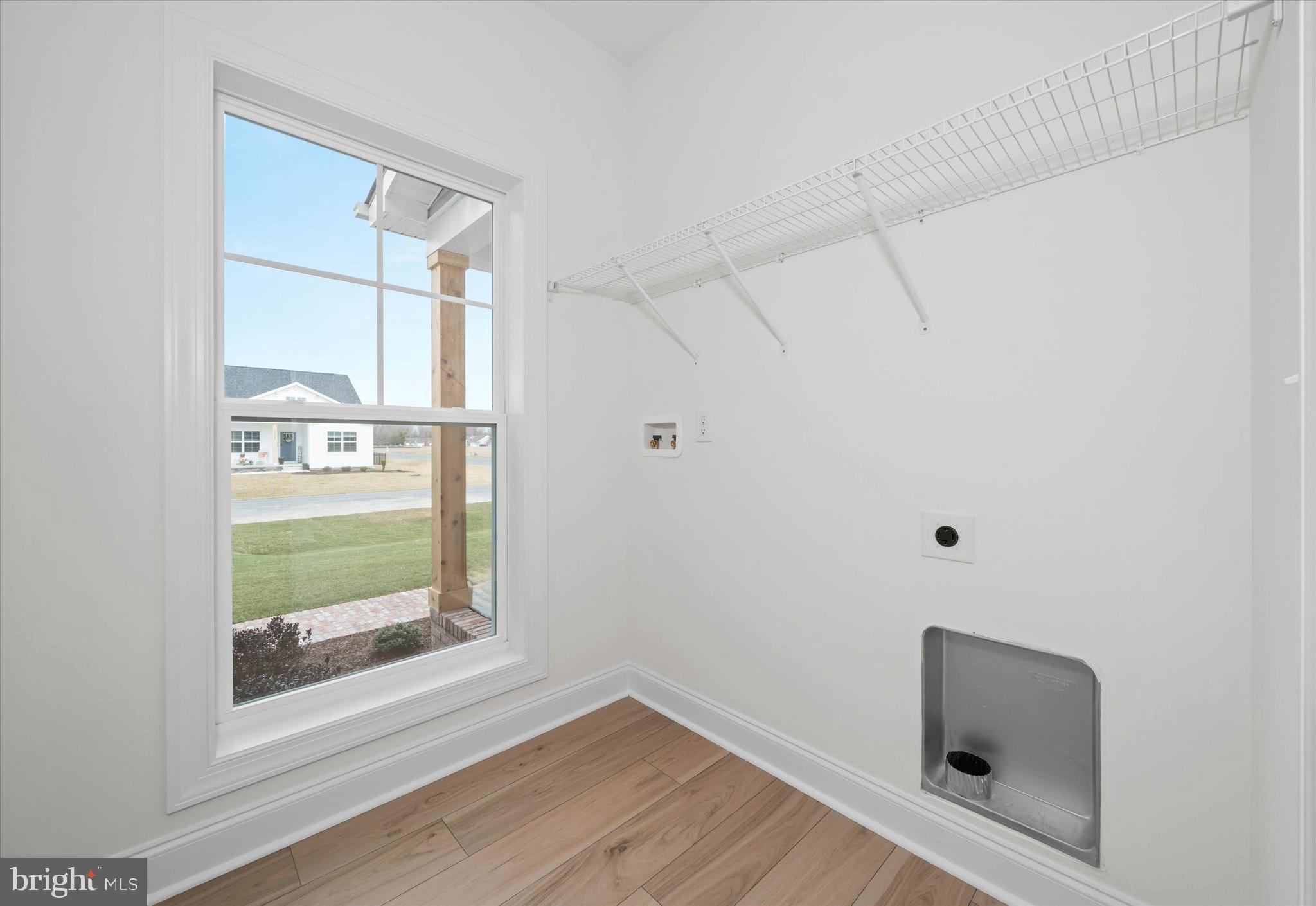 Lot#20 Hummingbird Road Ellendale, DE 19941 - Photo 22 of 41 a view of an empty room with wooden floor and a window