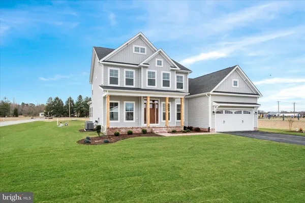 a front view of a house with a garden and yard