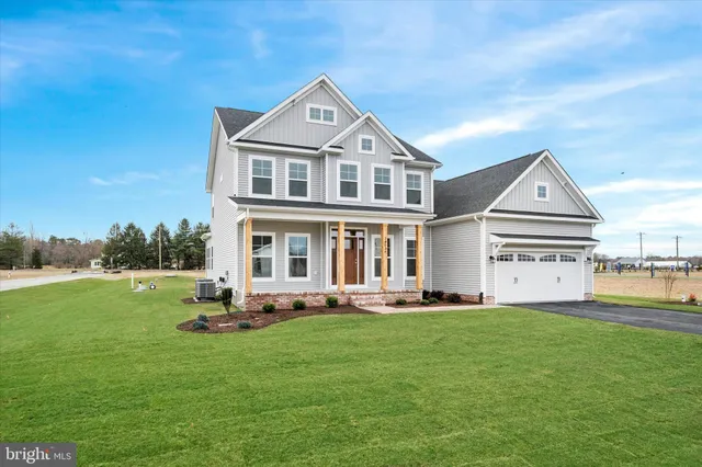a front view of a house with a garden and yard
