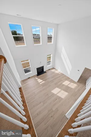 a view of wooden floor and windows in a room