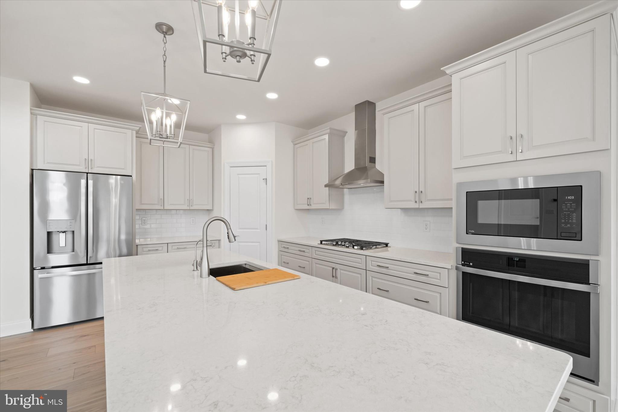 Lot#20 Hummingbird Road Ellendale, DE 19941 - Photo 7 of 41 a kitchen with granite countertop a refrigerator oven a sink and cabinets