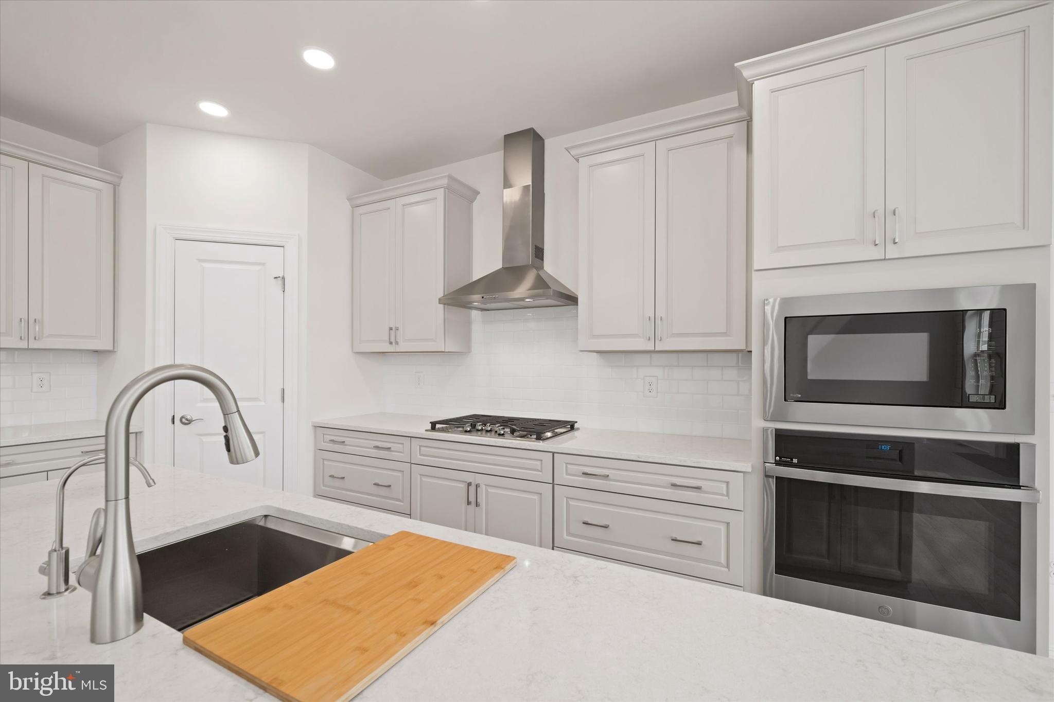 Lot#20 Hummingbird Road Ellendale, DE 19941 - Photo 9 of 41 a kitchen with stainless steel appliances granite countertop a stove a sink and a microwave