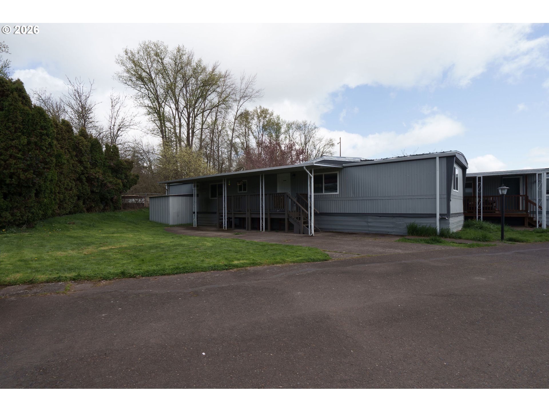 2010 Southwest 3rd Street, Unit 16 Corvallis, OR 97333 - Photo 1 of 16 a view of a house with a yard and large trees
