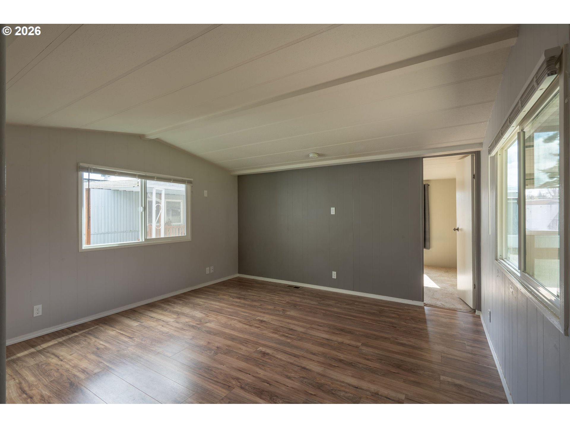 2010 Southwest 3rd Street, Unit 16 Corvallis, OR 97333 - Photo 4 of 16 a view of an empty room with wooden floor and a window