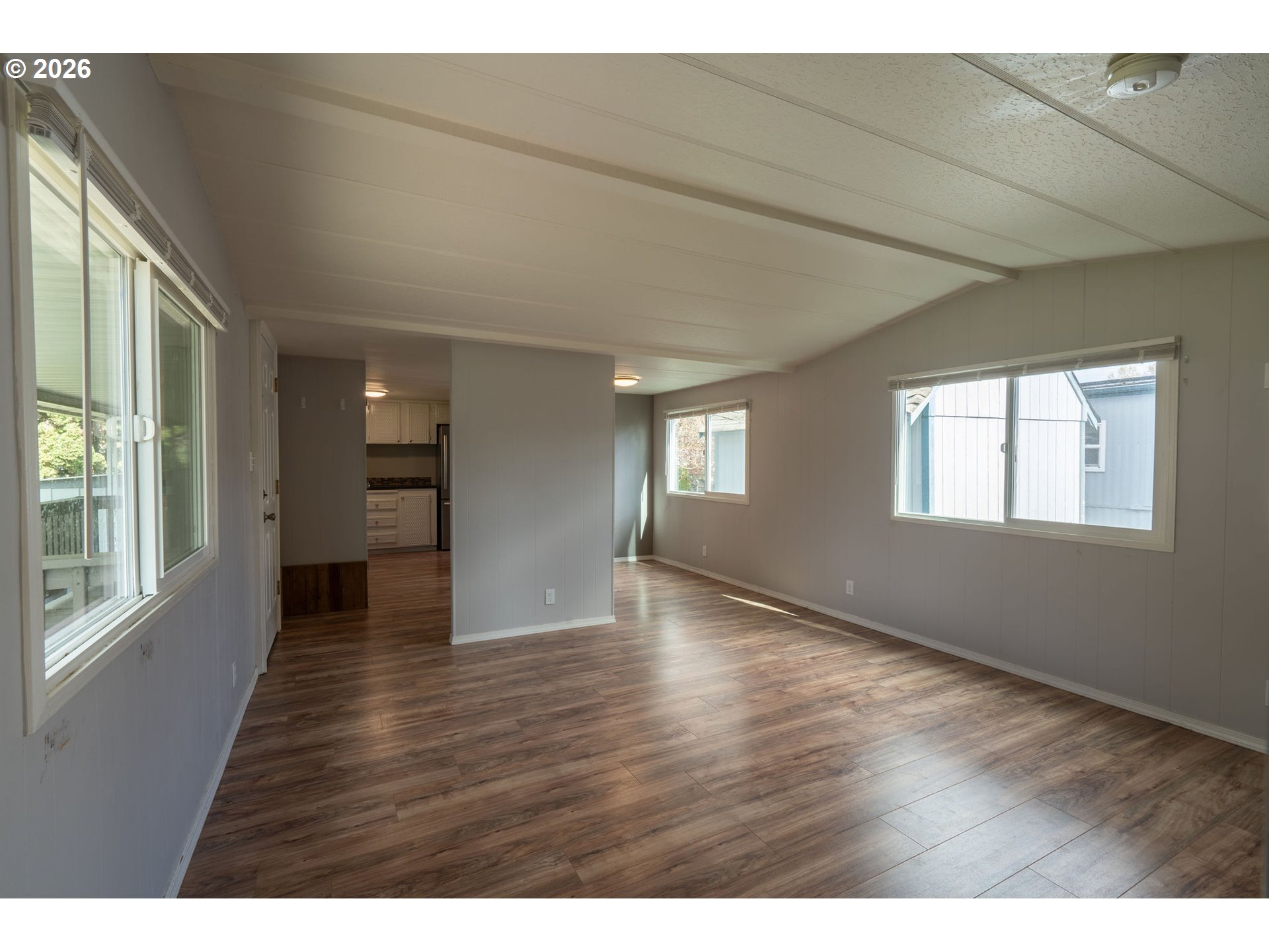 2010 Southwest 3rd Street, Unit 16 Corvallis, OR 97333 - Photo 6 of 16 a view of an empty room with wooden floor and a window